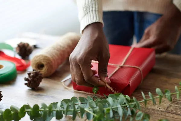 Black Woman Wrapping Present Red Paper Tying Twine — Stock Photo, Image