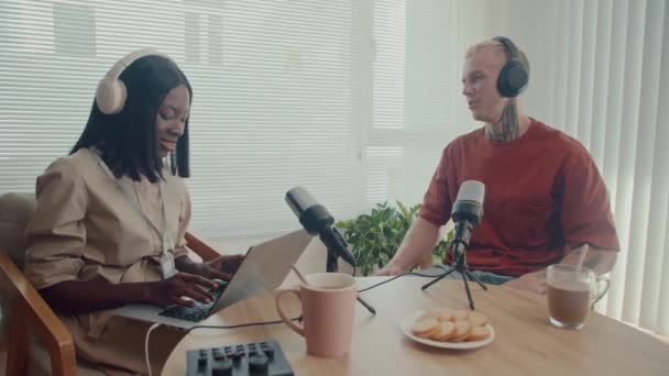 Mittlere Langzeitaufnahme Einer Podcasterin Die Männlichen Unternehmern Fragen Über Kopfhörer — Stockvideo