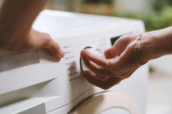 Stock image Closeup image of person setting cycle on washing machine