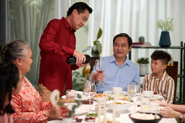 Smiling Vietnamese Man Pouring Wine Glass Brother Family Dinner — Stock Photo, Image