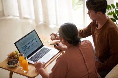 Üst düzey bir kadın torunundan faturaları internet üzerinden ödemesine yardım etmesini istiyor.