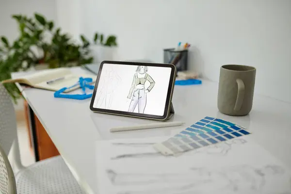 Sketch on digital tablet of fashion design student