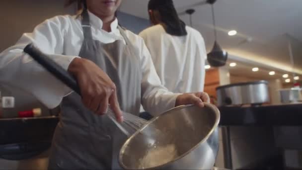Baixo Ângulo Chef Pastelaria Feminina Avental Usando Batedor Enquanto Amassa — Vídeo de Stock