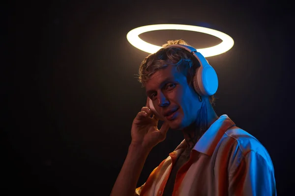 stock image Portrait of smiling meloman listening to music in headphones