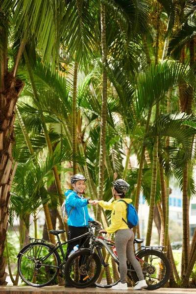 Happy Smiling Friends Making Fist Bump Cycling Palm Forest — Stock Photo, Image
