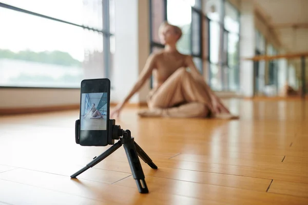 Contemporary dance teacher filming video for her social media on smartphone
