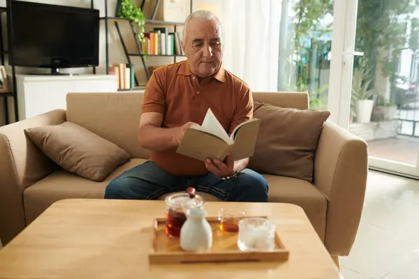 Senior Man Drinking Tea Reading New Detective Story His Favorite — Stock Photo, Image