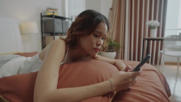 Handheld Tiro Cansaço Asiático Menina Mensagens Texto Celular Enquanto Deitado — Vídeo de Stock
