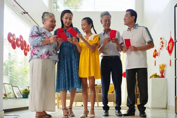 Excited Family Members Exchanging Lucky Money Envelopes Celebrating Tet — Stock Photo, Image