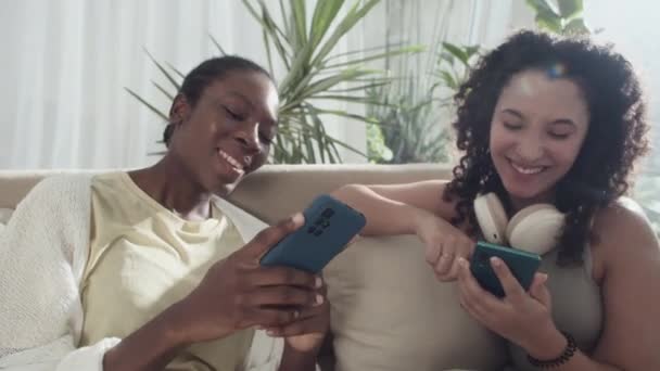 Medium Close Diverse Girlfriends Gossiping Using Smartphones While Spending Time — Stock Video