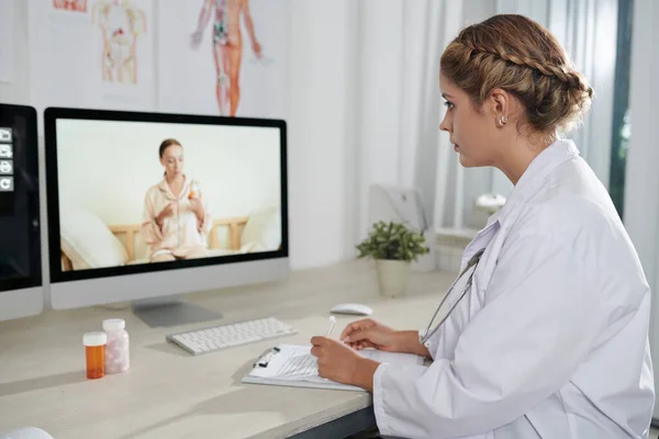 Serious Physisicn Listening Complaints Patient Telemedicine Session Taking Note Form — Stock Photo, Image