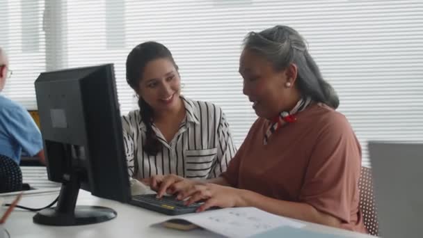 Средний Снимок Женщины Инструктора Направляющей Пожилую Женщину Компьютерными Навыками Время — стоковое видео