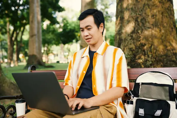 Young Asian Businessman Casualwear Looking Laptop Screen Typing While Sitting — Stock Photo, Image