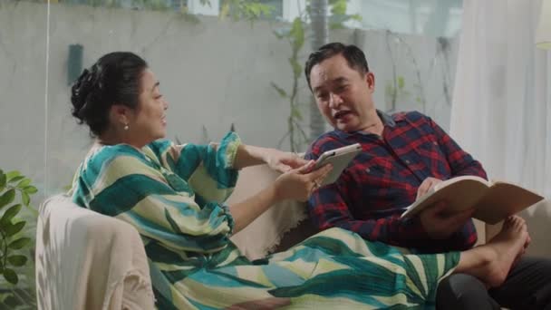 주말에 집에서 소파에 즐거운 아시아 남편의 휴대용 — 비디오
