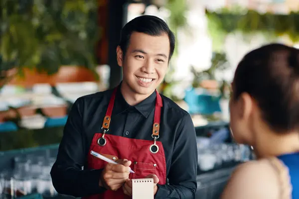 Cheerful Vietnamese Waiter Talking Restaurant Guest — Stock Photo, Image