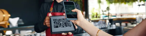 Web banner with restaurant guest scanning QR code with smartphone to upload menu