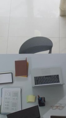 Modern ofisteki dizüstü bilgisayarlar ve belgelerle birlikte çalışma masasının tepesinden aşağıya doğru
