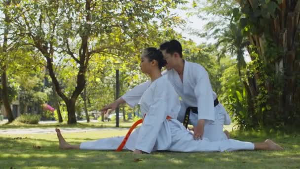 Long Shot Young Man Helping His Female Taekwondo Partner White — Stock Video