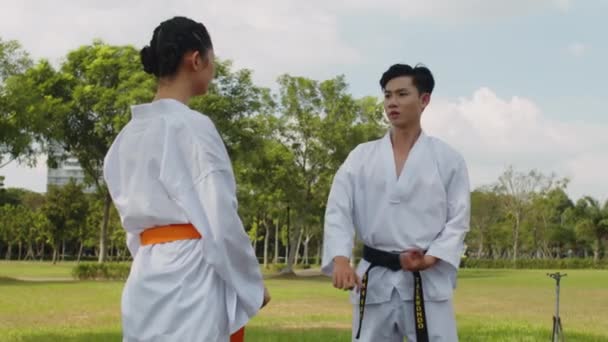 Medium Shot Female Athlete Grappling Male Opponent Taekwondo Class Outdoors — Stock Video