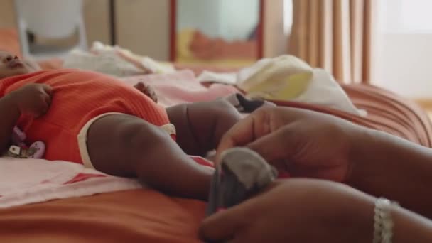 Medium Close Hands Mother Putting Socks Feet Baby Lying Blanket — Stock Video