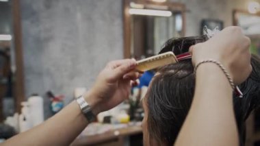 Berberin, kuaförde erkek müşteriye yeni saç kesimi yaptığı sahneler.