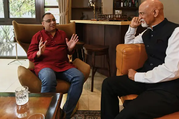 stock image Mature men having meeting at home, they sitting on sofa and talking to each other