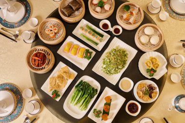 Restoranda çeşitli yemekleri olan yemek masasının en üst görüntüsü.