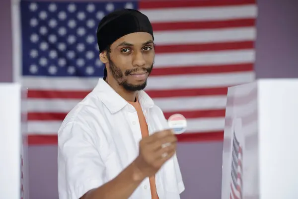 stock image Portrait of African American man with patriotic badge voting