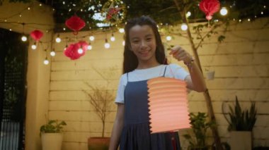 Sonbahar kutlaması için hazırlanmış fenerle kameraya poz veren Asyalı genç kızın portresi.