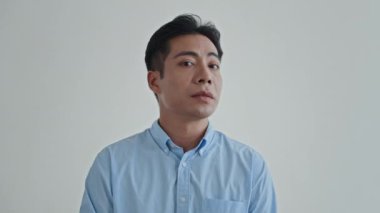 Küstah Asyalı adamın beyaz arka planda izole edilmiş görüntüsü. Boşluğu kopyala.