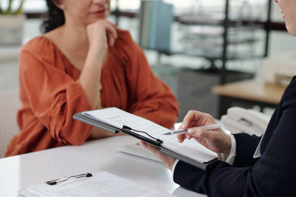 Social worker explaining contract to customer during her visit to social service