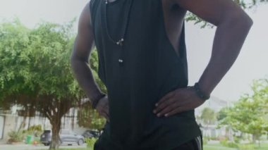 Yerel parkta egzersiz yaparken kalça daireleri çizen aktif Hintli adamın düşük açılı görüntüsü