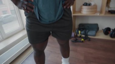 Spor kıyafetli kaslı zenci adamın portre fotoğrafını kaldır. Spor salonunda el ele tutuşup gülümseyerek kameraya poz ver.