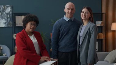 Afrika kökenli Amerikalı kadın danışman ve beyaz bir çiftin terapi odasında orta boy portresi.