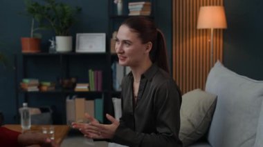 Oturum sırasında beyaz kadın hastayı destekleyen neşeli Afrikalı Amerikalı danışmanın görüntüsünü büyüt.