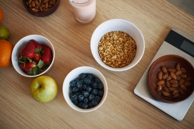 Besleyici bir kahvaltıya genel olarak çilek, yaban mersini, granola ve badem kâselerinin yanı sıra elmalar ve portakallar da dahildir.