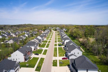 A quiet neighborhood in Copley Ohio. Copley is located in Ohio, not far from Cleveland and Akron. Residential houses line the street, with a few cars in the drives. clipart