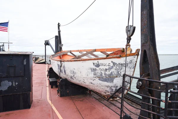Cleveland, Ohio/USA - September 29th 2022: A faded lifeboat aboard the William g mathers. It is there to rescue the crew in case of an emergency and the ship sinks or runs into other problems. The faded paint is peeling.