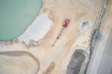 A view from above over a shovel at a sandpit.