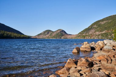 A relaxing day on Jordan's Pond in the late fall. The south and North Bubbles are seen in the background. clipart