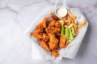 Buffalo chicken wings with celery and dip