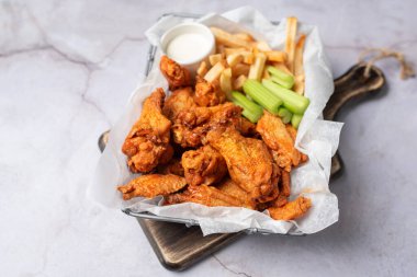 Buffalo chicken wings with celery and dip