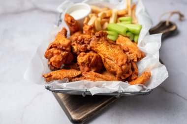 Buffalo chicken wings with celery and dip