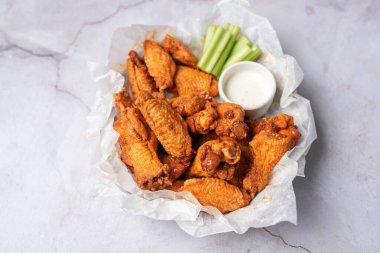 Buffalo chicken wings with celery and dip