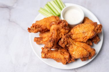 Buffalo chicken wings with celery and dip