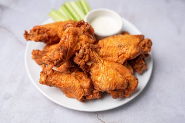 Buffalo chicken wings with celery and dip