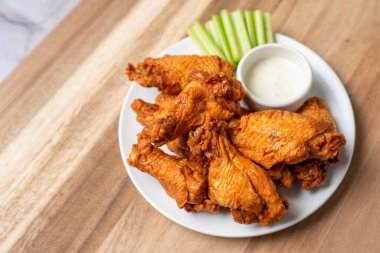 Buffalo chicken wings with celery and dip
