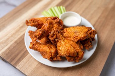 Buffalo chicken wings with celery and dip