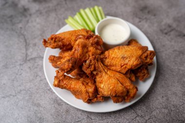 Buffalo chicken wings with celery and dip