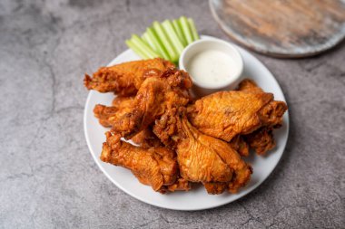 Buffalo chicken wings with celery and dip